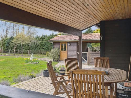 a patio with a table and chairs and a house at Holiday Home Undis - 660m from the sea by Interhome in Gedser