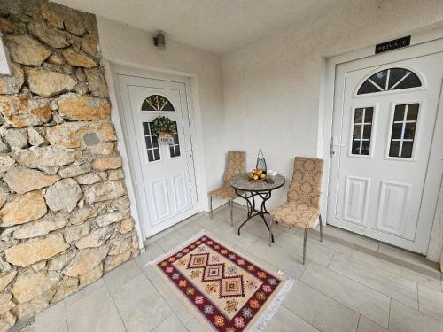 a room with a door and a table and chairs at Villa Ruscello in Grabovac