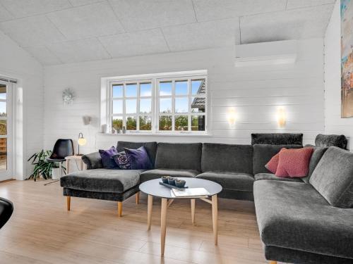 a living room with a couch and a table at Holiday Home Gizella - 500m to the inlet by Interhome in Spottrup