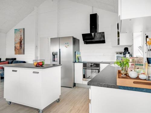 a kitchen with white cabinets and a counter top at Holiday Home Gizella - 500m to the inlet by Interhome in Spottrup