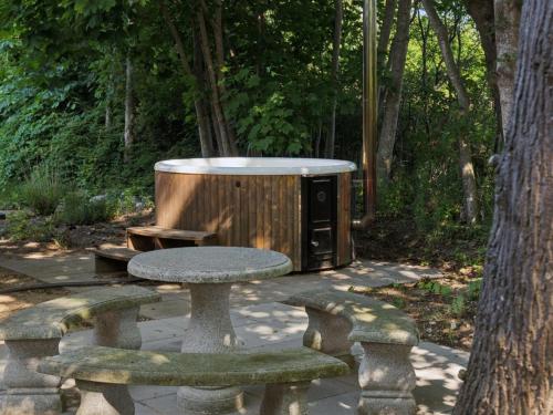 a picnic table and a tub in a park at Holiday Home Thora - 800m from the sea by Interhome in Nyrup