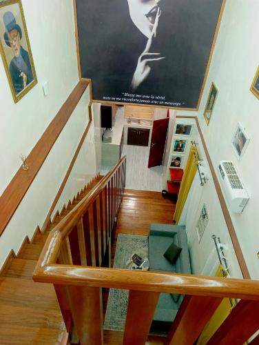 a staircase with a large painting on the wall at La trinité in Brazzaville