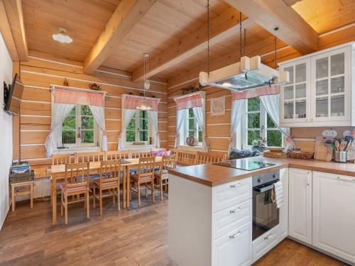 a kitchen and dining room with a table and chairs at Holiday Home Roubenka Maleč by Interhome in Strašín