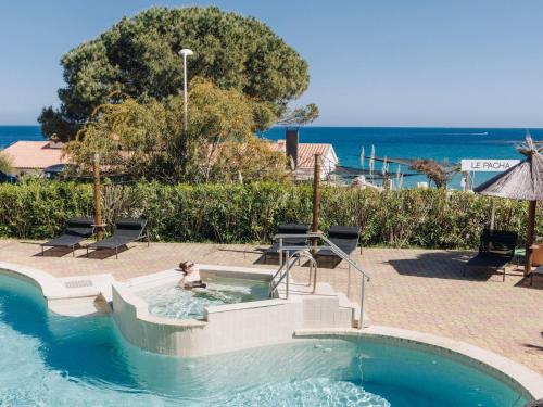 a person is in a swimming pool in a swimming pool at Apartment Le Télémaque 2 pièces Mezzanine by Interhome in Conca