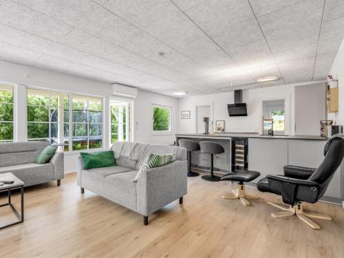 a living room with a couch and a table at Holiday Home Anabela - from the sea by Interhome in Hadsund