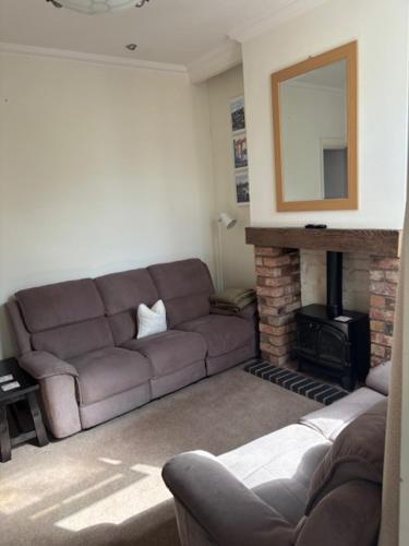 a living room with a couch and a fireplace at Holiday Home in Kidderminster in Kidderminster