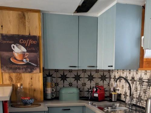 a kitchen with blue cabinets and a sink at Apartment Arlinn Apartment by Interhome in Frutigen