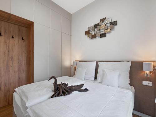 a bedroom with a white bed with a swan on it at Apartment Javorná Lodge by Interhome in Javorná