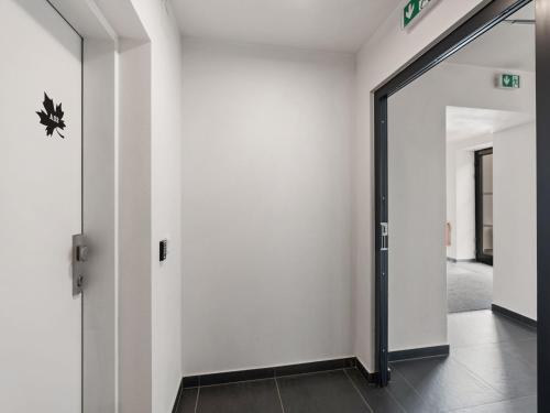 an open door in a hallway with white walls at Apartment Javorná Lodge by Interhome in Javorná