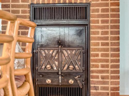 a black door in a brick wall at Holiday Home Eva - 9km to the fjord by Interhome in Brovst