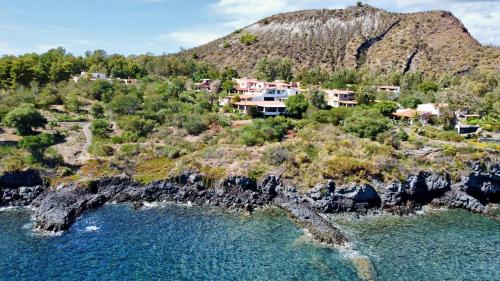 an aerial view of a house on a rocky island in the water at JERA Holiday Collection VULCANO TRE - Sea View in Vulcano