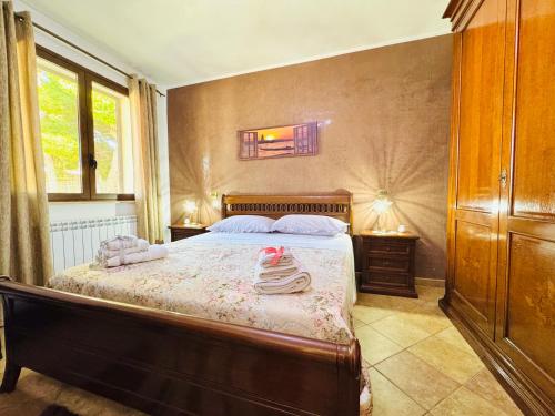 a bedroom with a bed with towels on it at La Cinisara in Carini