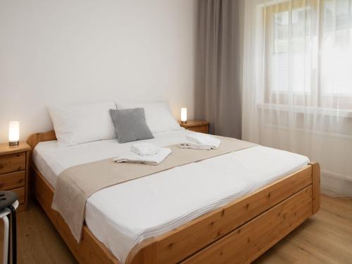 a bedroom with a bed with white sheets and a window at Apartment La Siala Apt-19 by Interhome in Falera