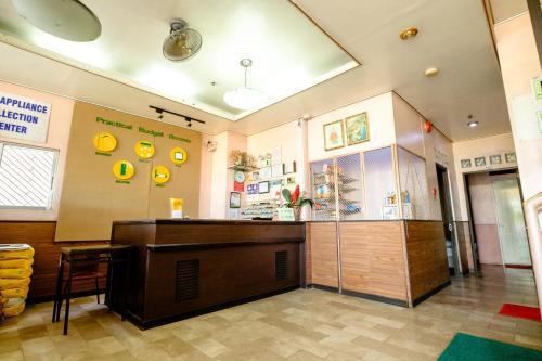 a restaurant with a counter in the middle of a room at GV Hotel - Pagadian in Pagadian