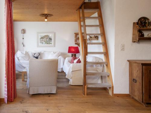a living room with a spiral staircase and a couch at Apartment La Siala Apt-56A by Interhome in Falera