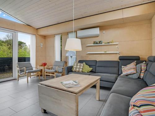 a living room with a couch and a table at Holiday Home Ginne - 1km to the fjord by Interhome in Løgstør