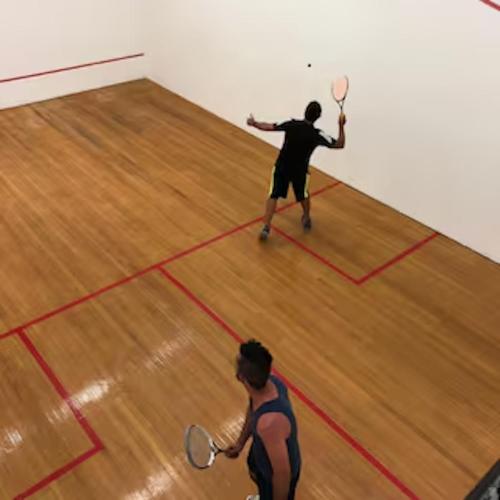 two men playing a game of tennis on a court at Classic Coastal Beachfront, Surfers Paradise-Pool in Gold Coast