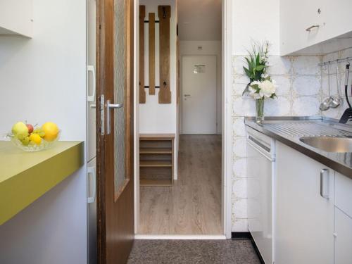 a kitchen with a door leading into a hallway at Apartment La Siala Apt-51 by Interhome in Falera