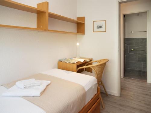a bedroom with a bed and a desk and a shower at Apartment La Siala Apt-51 by Interhome in Falera