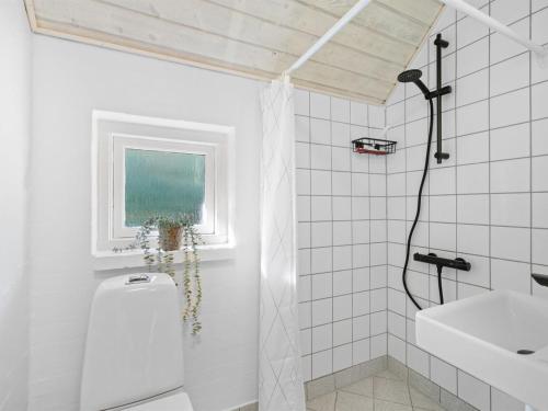 a bathroom with a shower and a toilet and a sink at Holiday Home Erle - 830m from the sea by Interhome in Nyby