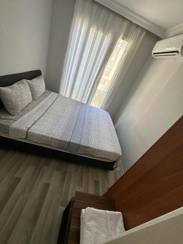 a small bedroom with a bed and a window at İzmir homes in Buca