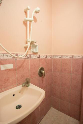 a bathroom with a sink and a bath tub at GV Hotel - Masbate in Masbate