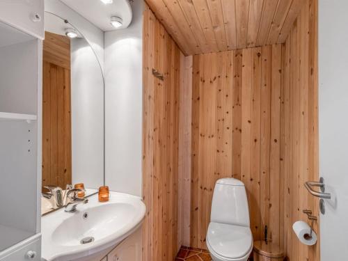 a bathroom with a white toilet and a sink at Holiday Home Blesse - 500m to the inlet by Interhome in Skjern