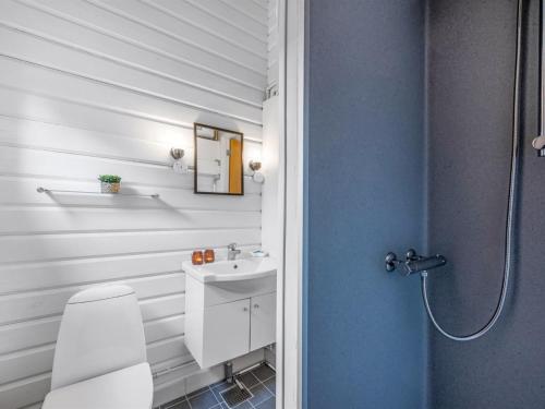 a bathroom with a toilet and a sink at Holiday Home Blesse - 500m to the inlet by Interhome in Skjern
