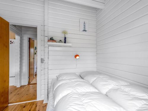 a white bedroom with a large bed in it at Holiday Home Blesse - 500m to the inlet by Interhome in Skjern