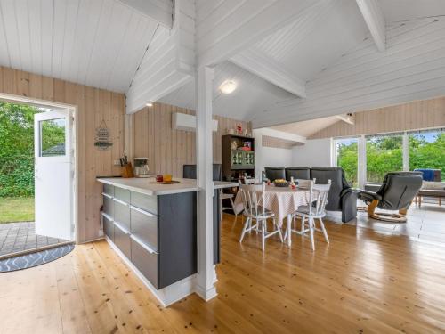 a kitchen and living room with a table and chairs at Holiday Home Blesse - 500m to the inlet by Interhome in Skjern
