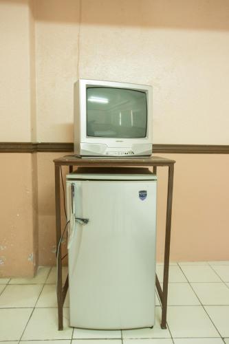 a television and a microwave on top of a refrigerator at GV Hotel - Masbate in Masbate