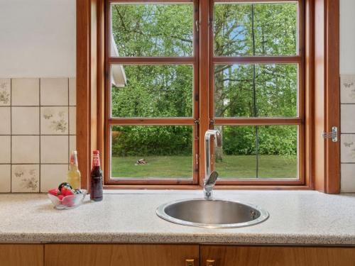 a kitchen counter with a sink and a window at Holiday Home Andri - 1-5km from the sea by Interhome in Rønne