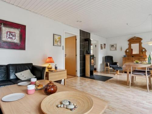 a living room with a couch and a table at Holiday Home Andri - 1-5km from the sea by Interhome in Rønne