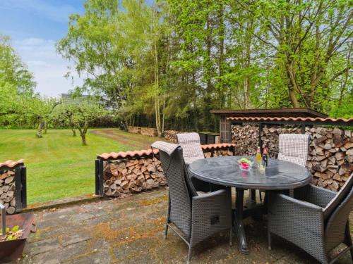 a patio with a table and chairs and a fence at Holiday Home Andri - 1-5km from the sea by Interhome in Rønne