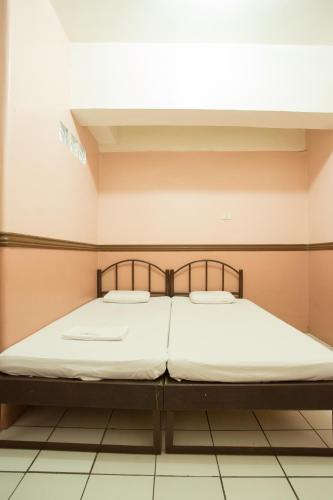 a large bed in a room with at GV Hotel - Masbate in Masbate