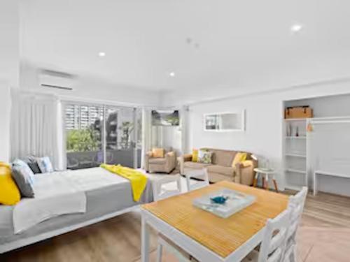 a living room with a couch and a table at Classic Coastal Beachfront, Surfers Paradise-Pool in Gold Coast