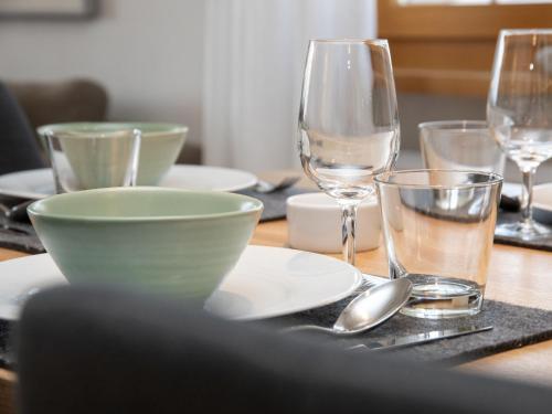 a table with a bowl and glasses on a table at Apartment La Siala Apt-7 by Interhome in Falera