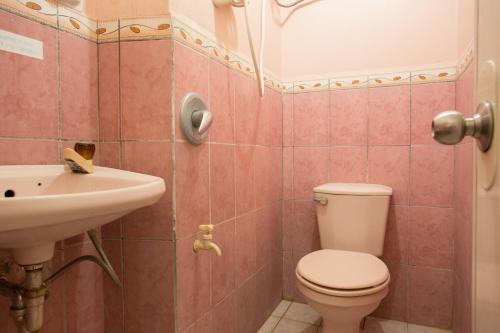 a bathroom with a toilet and a sink at GV Hotel - Masbate in Masbate