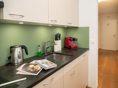 a kitchen with a sink and a counter top at Apartment La Siala Apt-7 by Interhome in Falera