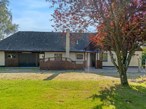 a house with a tree in front of it at Holiday Home Eiko - 400m to the fjord by Interhome in Storvorde