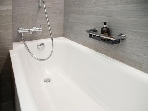 a bathroom with a shower and a tub with a sink at Apartment La Siala Apt-7 by Interhome in Falera