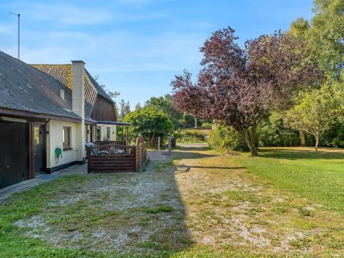 a yard next to a house with a tree at Holiday Home Eiko - 400m to the fjord by Interhome in Storvorde
