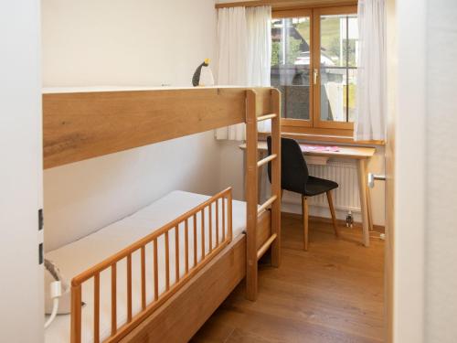 a room with two bunk beds and a desk at Apartment La Siala Apt-7 by Interhome in Falera