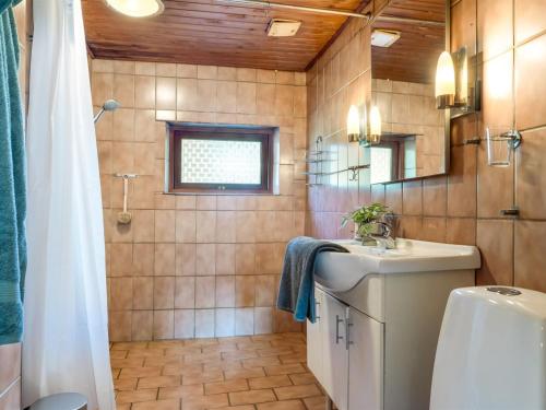 a bathroom with a sink and a toilet and a shower at Holiday Home Eiko - 400m to the fjord by Interhome in Storvorde
