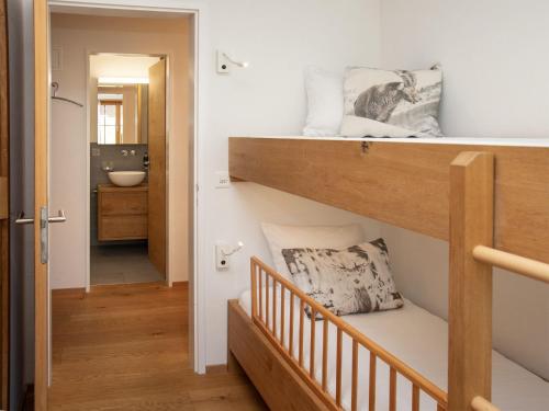 a small room with a bunk bed and a bathroom at Apartment La Siala Apt-7 by Interhome in Falera