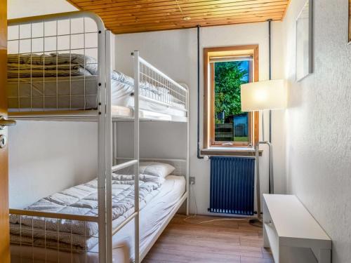 a bunk bed room with two bunk beds and a window at Holiday Home Eiko - 400m to the fjord by Interhome in Storvorde