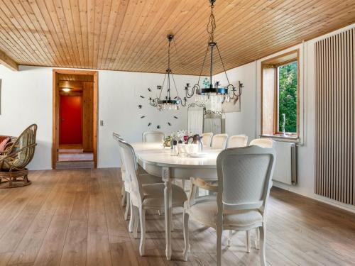 a dining room with a white table and chairs at Holiday Home Eiko - 400m to the fjord by Interhome in Storvorde
