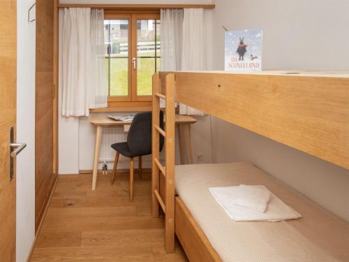 a small room with a bunk bed and a desk at Apartment La Siala Apt-7 by Interhome in Falera