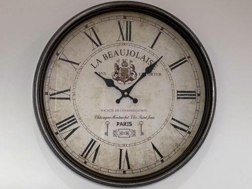 a clock with roman numerals on a wall at Apartment Forres View by Interhome in Forres