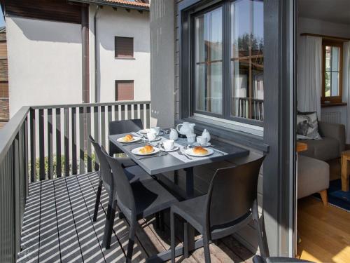 a table on a balcony with food on it at Apartment La Siala Apt-7 by Interhome in Falera